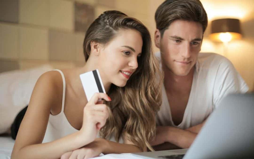 A happy couple shopping online using their credit card without any qualms